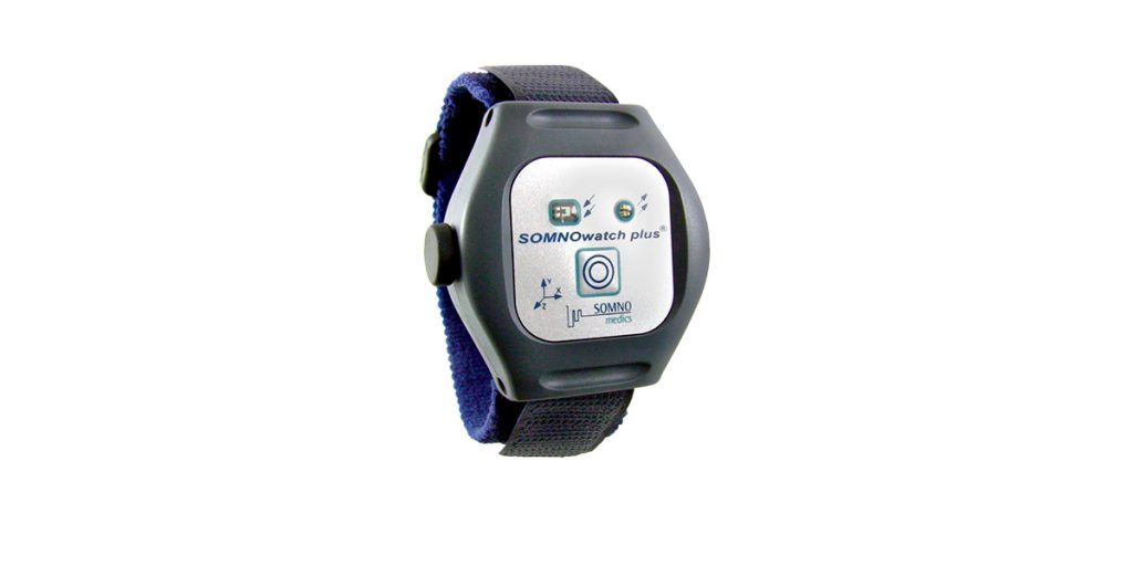 A picture of the SOMNOwatch Plus wearable datalogger and strap.